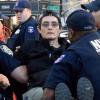 Benz being carried by police officers.